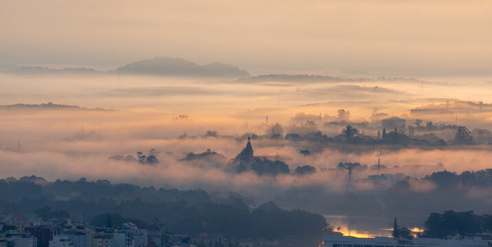 The view of Da Lat from Du Sinh Cemetery towards the city center. Da Lat on a morning shrouded in mist and early sunlight, a magical morning light. Beautiful Vietnamese scenery.