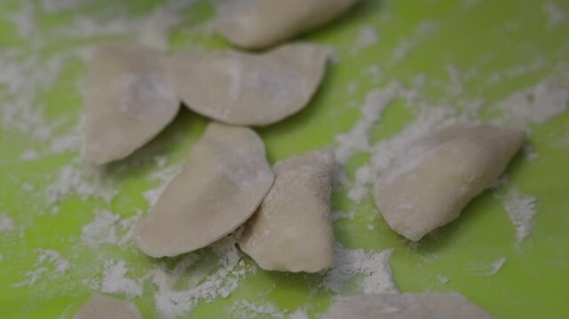 Close up of hands making traditional homemade dumplings with cottage cheese