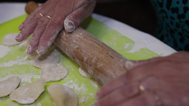 Close up of hands making traditional homemade dumplings with cottage cheese