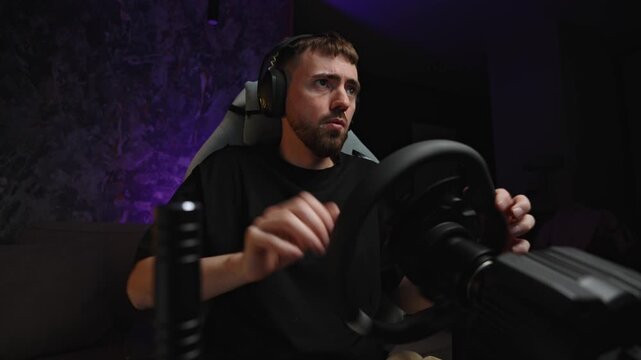 Focused gamer at racing wheel in dark studio, headset on, hands gripping wheel, purple backlight, concentrated expression driving