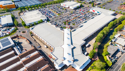 Fototapeta premium Aerial view above a UK retail park with popular shops and stores