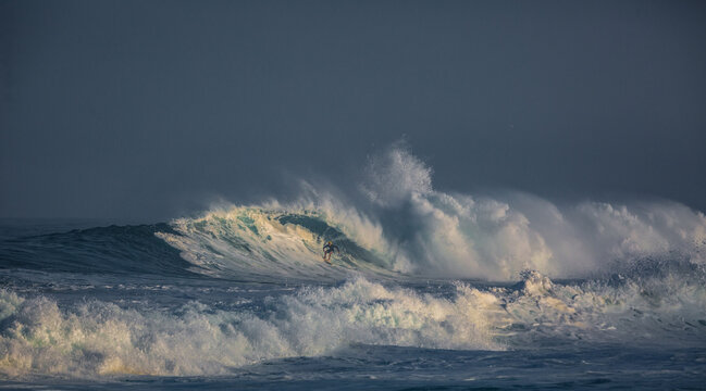 Surfer riding wave. Ocean scenery with copyspace. Huge waves crashing in ocean. Seascape environment background. Water texture with foam and splashes. Hawaiian surfing at Northshore in Oahy island

