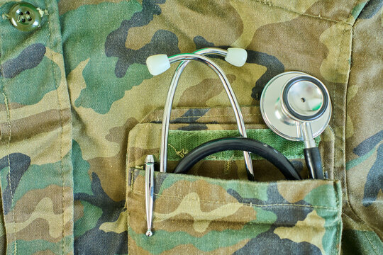 Close up of stethoscope and pen inmilitary doctor robe pocket. Concept Of The Global Healthcare, Medicine And Insurance with copy space.