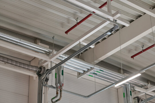 Pipes and lighting in an industrial ceiling space