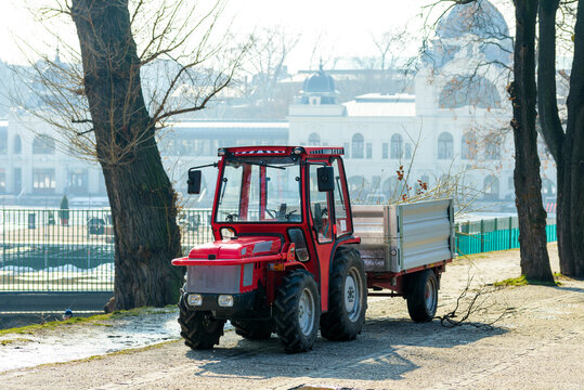 Tractor carries load through winter morning park