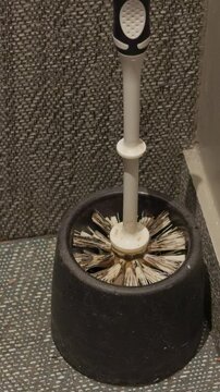 Unsanitary conditions with neglected cleaning tools. Restroom left unclean with grimy brushes and dirt buildup. Restroom was poorly cleaned and hygiene standards were completely disregarded