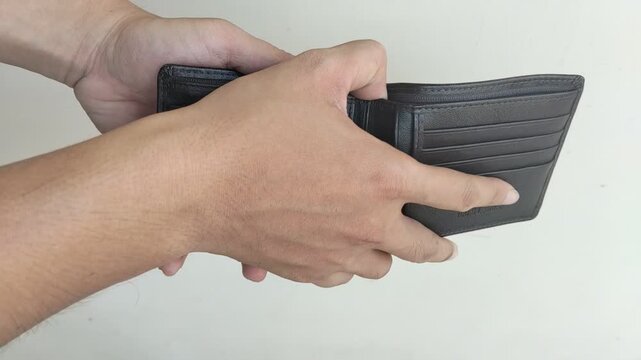 Man Opening Empty Wallet Showing No Money Isolated on White Background
