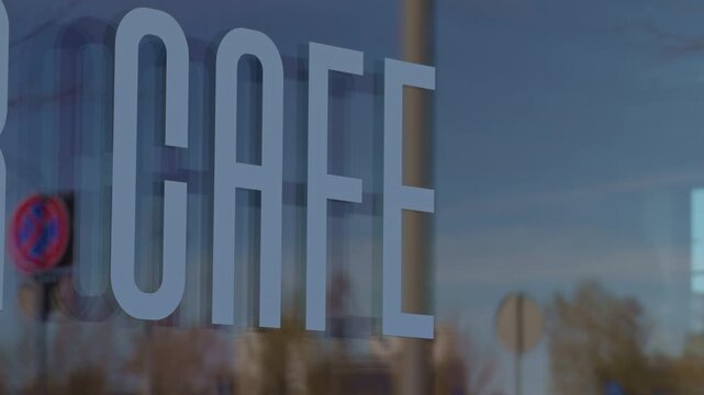 Dusk street reflection of cafe window, layered cityscape mirrored in glass, cool blue tones, passing cars and faint interior glow, atmospheric evening vibe, slow motion footage texture