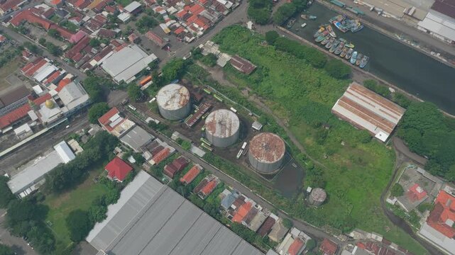 Industrial oil tanks in probolinggo's urban landscape