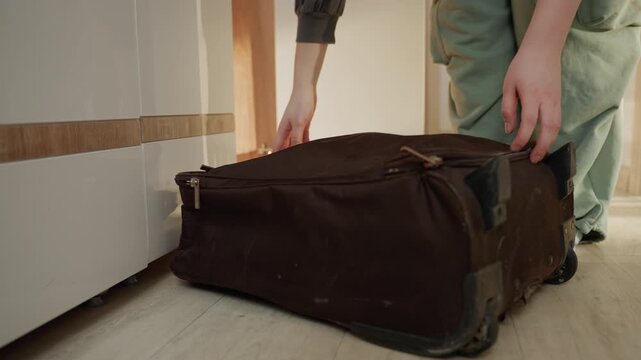Professional organizing travel essentials. Medical staff packing belongings for morning hospital duty. Healthcare professional carefully arranges documents and clothing for upcoming hospital shift