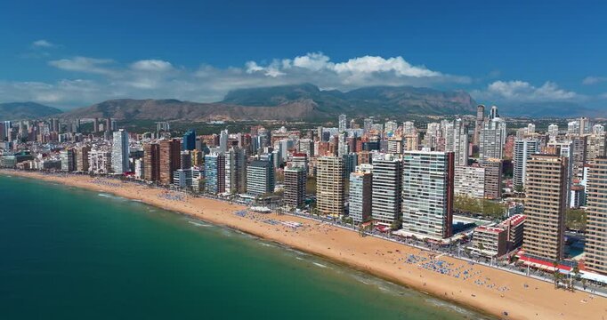 Benidorm Spain aerial view featuring skyline skyscrapers along Mediterranean coast. High angle drone panorama Levante beach summer travel exploration destination.