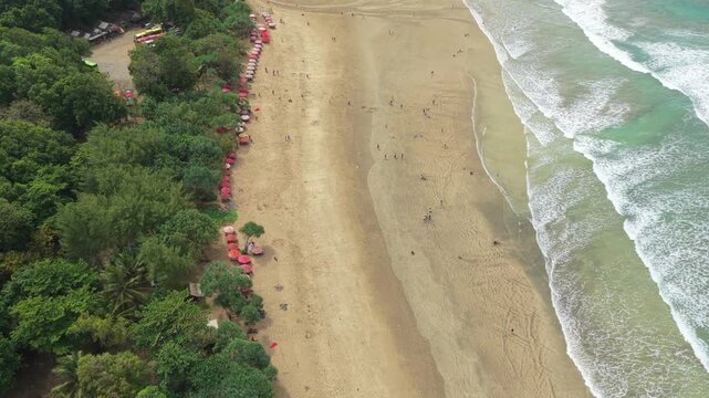 Aerial view of tropical sandy beach with ocean waves