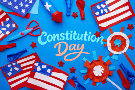 Constitution Day school project with handmade USA crafts, paper flags and decorations on blue background, creative classroom activity concept