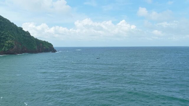 Scenic java island coastal landscape with a fishing boat