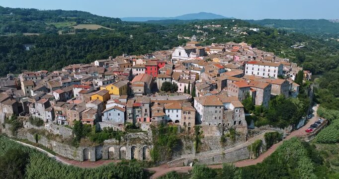 Orte Italy ancient town aerial cinematography. Old stone buildings colorful facades terracotta roofs scenic landscape drone footage summer travel.