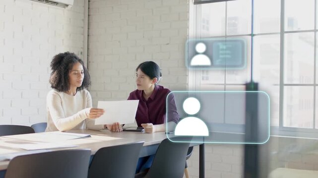 Left woman sliding paper and activating holo avatars on glass as coworkers reviewing business data