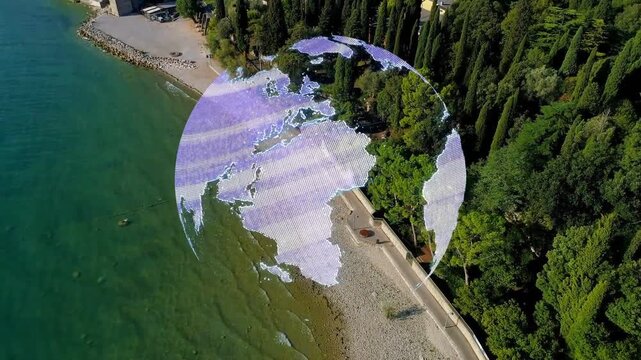 Drone panning down, globe forming, rotating, breaking into dots, revealing coastal town horizon
