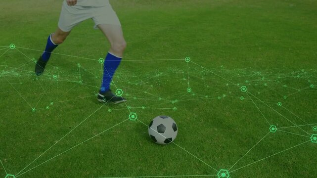 soccer player nearing and kicking ball on grass, green overlay tracking path, sending ball forward
