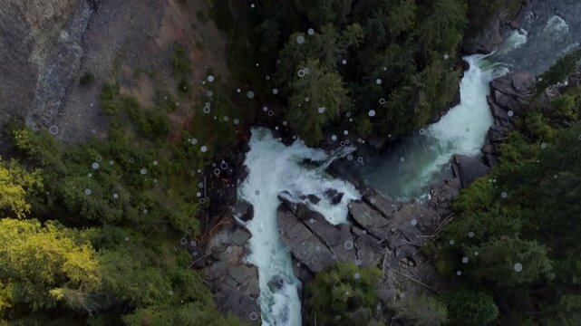 Teal water entering frame starting camera tracking rushing stream past rocks showing yellow trees