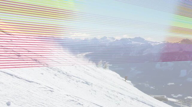 Two skiers pushing off for descent carving down slope kicking powder exiting frame leaving tracks