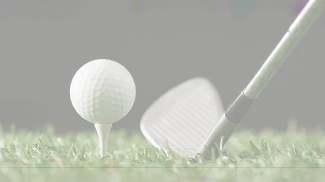 Golf ball remaining on tee while approaching iron starting swing, hitting turf for swing study