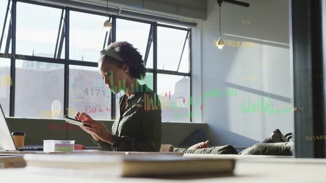 Woman shifting laptop work to phone, tapping device and bringing finance graphs up while calling