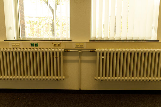Image of vintage radiator and windows in an old building interior. Suitable for industria