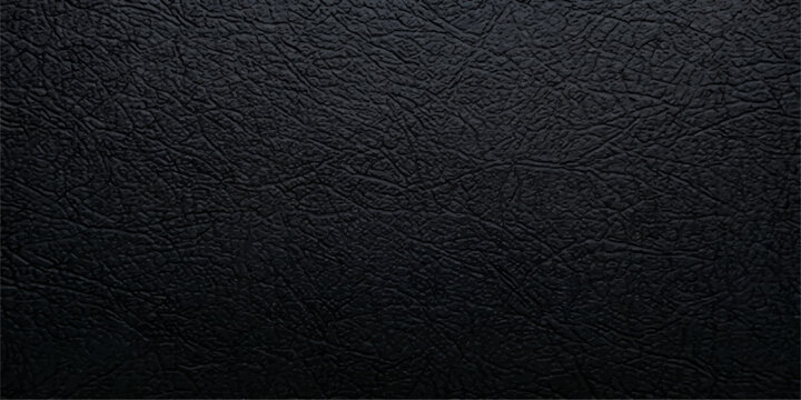 A detailed view captures the textured surface of sleek, dark leather. The play of light and shadow over the subtly wrinkled surface reveals its quality. 