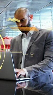 Vertical video: Businessman typing laptop, causing yellow HUD, finishing work and taking laptop