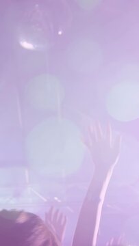 Vertical video: Lensflare pulsing, forearm rising, others joining, crowd reacting to music