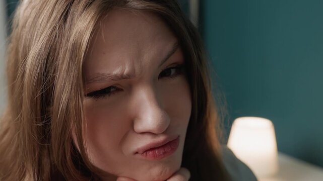 Playful caucasian teen making silly faces in cozy bedroom with teal wall and lamp, closeup shots capture pout, wink, grin, thoughtful pose, influencer rehearsal, morning mirror routine, authentic