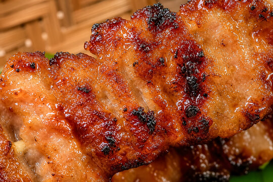 Grilled meat skewers served on a plate with wooden background and vibrant colors in a kitchen setting