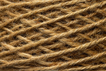 Obraz premium Macro shot of natural brown jute rope coil texture background,Extreme close-up shot showing the detailed texture and intricate weaving of a natural brown jute rope spool, perfect for rustic background