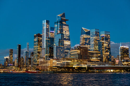 Hudson Yards skyline with Edge observation deck at night. Modern skyscrapers of Hudson Yards district in Manhattan with illuminated buildings and The Edge at night.