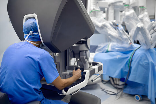 Doctor using robotic surgery console in a modern operating room