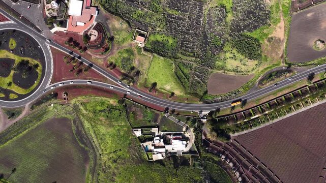 Drone flies over a unique roundabout and green landscape in Lanzarote