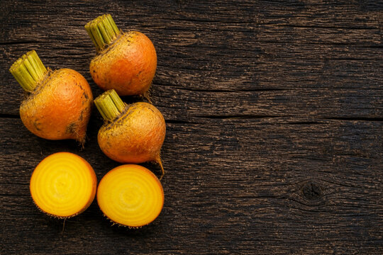 Yellow beet on rustic wooden table copy space organic root vegetable background