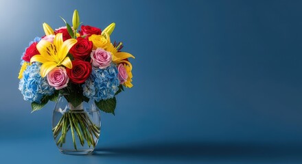 Fototapeta premium A bouquet of fresh colorful flowers in a clear glass vase sits elegantly against a solid blue background with soft natural lighting, summer, petals, home