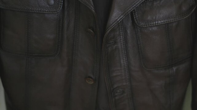 Close-up of a premium brown leather jacket texture and details