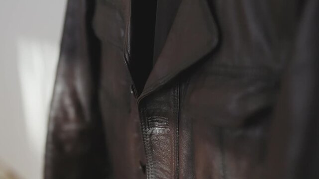 Close-up of a premium brown leather jacket texture and details