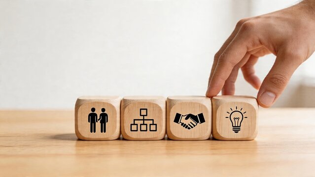 Business management strategy planning teamwork collaboration success organizational structure partnership agreement new idea concept hand placing wooden block with icons