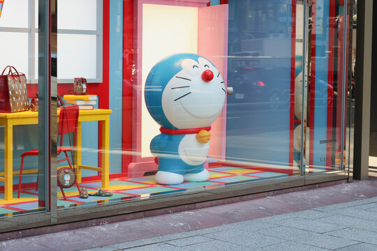 TOKYO, JAPAN - February 3, 2021: Gucci store window display in Tokyo's Ginza area featuring the character Doraemon and related products.