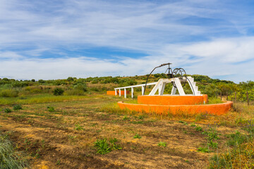 Fototapeta premium Traditional rural well in open Algarve countryside landscape