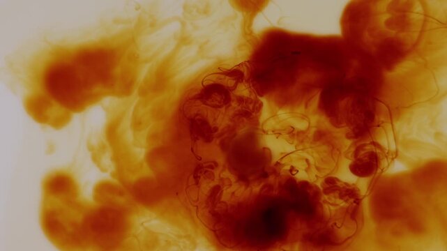 Iodine dissolving in water creating abstract flowing patterns and organic motion