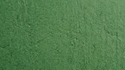 Fototapeta premium A close-up shot of a textured green wall. The wall has a rough, uneven surface with visible bumps and ridges.