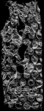 Bubble Wrap Texture: A close-up view of bubble wrap, showing a torn area, capturing the delicate yet resilient nature of the material in a striking display of texture.