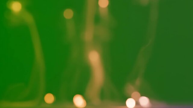 Blurry lights on green background.