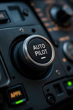 Advanced aircraft autopilot control knob on cockpit dashboard, modern aviation technology interface, pilot navigation system control panel close-up with precision engineering