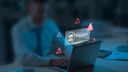 Online Payment Fraud Warning During Mobile Transaction as Man Uses a Laptop and Smartphone for Digital Banking, Facing Potential Fraud, Phishing, and Cybersecurity Threats in Financial Transactions © sahanaj