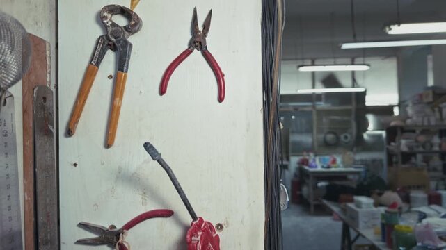 Vintage Pliers and Hand Tools Hanging on a Workshop Wall